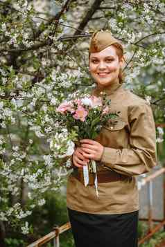 女孩苏联军事统一的开花树手女孩美丽的花束