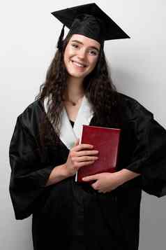 学生书毕业袍帽准备好了完成大学未来领袖科学院士年轻的女人黑色的礼服微笑