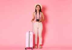 旅游夏天假期假期在国外概念完整的长度快乐有吸引力的亚洲女孩旅游旅行者稻草他相机手提箱笑微笑粉红色的背景