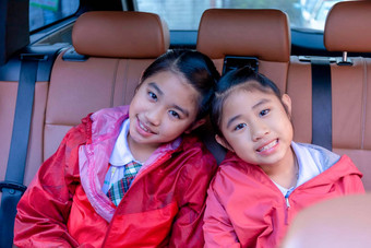 快乐学生微笑享受路旅行车姐妹微笑相机内部车早....亚洲瘦坐着车学校家庭车