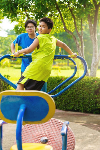 孩子玩户外操场上孩子们玩学校幼儿园院子里活跃的孩子色彩斑斓的摇摆不定的健康的夏天活动孩子们男孩摆动热带花园