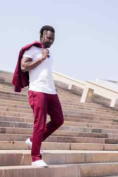 时尚的非洲男人。走城市楼梯