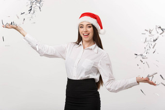 圣诞节<strong>庆祝</strong>活动概念年轻的业务女人扔五彩纸屑<strong>庆祝</strong>圣诞节一天孤立的白色背景