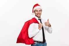 圣诞节概念英俊的业务男人。庆祝快乐圣诞节快乐一年穿圣诞老人他圣诞老人红色的大袋