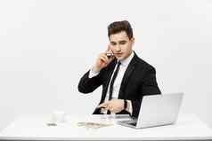 业务概念肖像年轻的成功的商人工作明亮的办公室移动PC会说话的电话