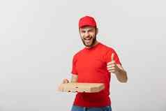 披萨交付概念年轻的英俊的交付男人。显示披萨盒子持有拇指标志孤立的白色背景