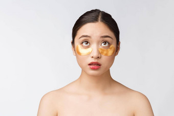 亚洲美少年女人护理皮肤黄金眼睛面具补丁眼睛担心