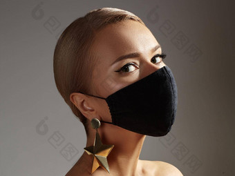 美丽的女人黑色的脸面具时尚眼睛化妆黄金配件保护卫生病毒流感大流行