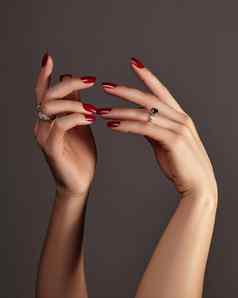 优雅的女手明亮的修指甲广场指甲红色的过来这里波兰的奢侈品时尚风格北京瑞珠宝