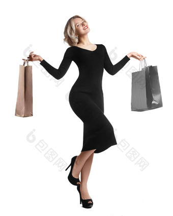 购物年轻的女人持有袋孤立的白色工作室背景爱时尚销售快乐金发碧眼的女孩黑色的奢侈品glomour衣服购物者手袋礼物