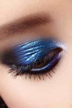 特写镜头宏女人时尚化妆眼睛闪闪发光的蓝色的庆祝化妆完美的颜色眼影膏长睫毛