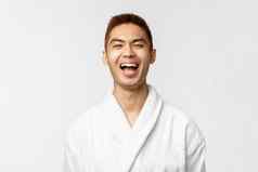 美水疗中心休闲概念快乐的亚洲男人。支出周末放松热弹簧穿浴袍笑享受假期休息酒店度假胜地站白色背景