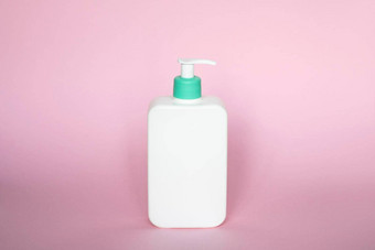 液体容器过来这里乳液奶油洗发水浴泡沫化妆品塑料瓶自动售货机泵粉红色的背景化妆品包装模型复制空间