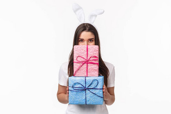 庆祝活动假期礼物概念肖像快乐可爱的年轻的女孩可爱的兔子耳朵隐藏脸包装礼物微笑加沙站白色背景