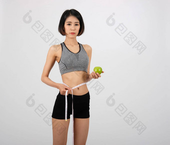 <strong>运动健身</strong>女人运动服装测量腰磁带健康的体育运动生活方式