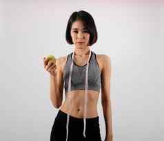 运动健身女人运动服装苹果健康的体育运动生活方式