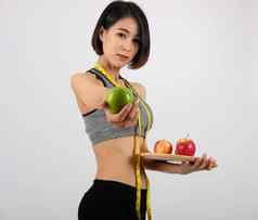 运动健身女人运动服装苹果健康的体育运动生活方式
