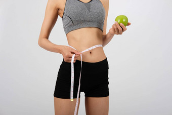 运动健身女人运动服装测量腰磁带健康的体育运动生活方式