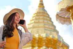 女人旅行者旅游背包说话移动聪明的电话旅行旅程旅行概念