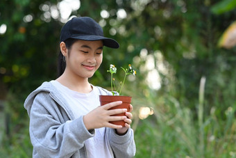 微笑亚洲女孩持有盆栽植物手保存世界环境一天保存环境地球一天