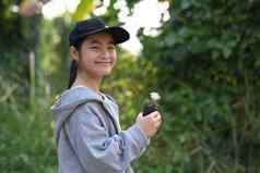 快乐的亚洲女孩持有盆栽植物模糊绿色自然背景保存世界环境一天保存环境地球一天