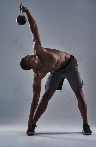 锻炼水壶贝尔完整的长度拍摄运动年轻的男人。工作水壶贝尔