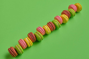 彩色的macaron蛋白杏仁饼干甜蜜的meringue-based糖果绿色背景特写镜头复制空间