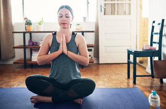 聚焦呼吸裁剪拍摄有吸引力的年轻的女人坐着瑜伽席冥想首页