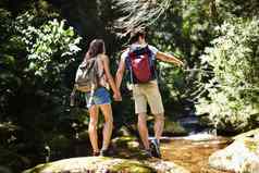 森林探险家后视镜拍摄年轻的夫妇徒步旅行森林