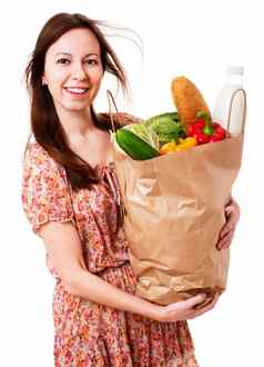 年轻的女人持有大袋身体健康食品杂货股票图像放大