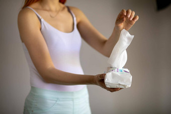 女人采取湿婴儿湿巾包装护理清洁皮肤表面