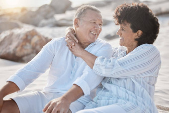 高级混合比赛夫妇坐着海滩拥抱微笑一天海滩拉美裔丈夫妻子快乐显示感情浪漫的一天海滩