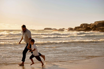 单爸爸<strong>玩儿</strong>子海滩一天高加索人单父亲成键儿子锻炼日落可爱的男孩享受免费的时间父