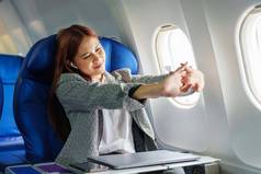 肖像成功的亚洲女商人企业家正式的西装飞机业务类醒着的休息航班