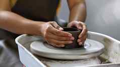 年轻的女人创建手工制作的陶瓷碗生粘土陶器轮工艺车间