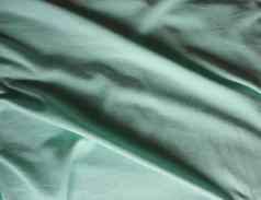 皱巴巴的蒂尔绿色织物纹理背景