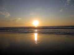 日落海洋波崩溃海滩一半月亮湾