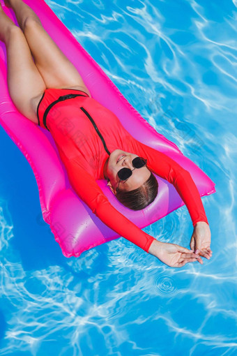 快乐年轻的女人太阳镜粉红色的<strong>比基尼</strong>浮动充气床垫池夏天假期概念旅行海