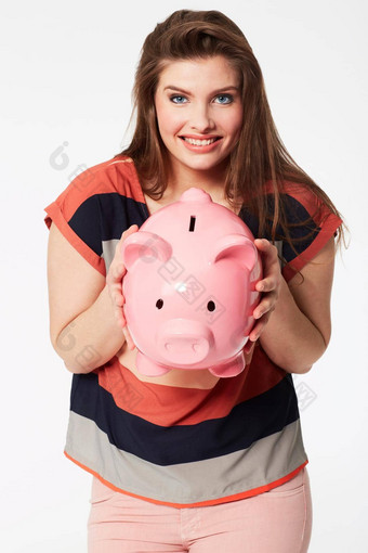 爱发现钱衣服礼物美丽的年轻的女人持有小猪银行