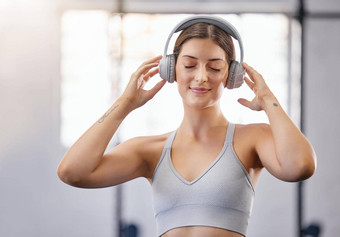活跃的年轻的高加索人女人听放松音乐耳机采取打破锻炼健身房女运动员住动机平静音乐锻炼健身中心