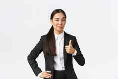 很高兴女企业家夫人老板黑色的西装满意工作显示竖起大拇指点头批准赞美伟大的工作站白色背景