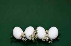 节日复活节鸡蛋白色小花绿色背景