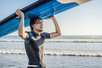 男人。携带冲浪板头关闭英俊的的家伙冲浪板头海滩肖像男人。携带冲浪板藏头微笑海滩