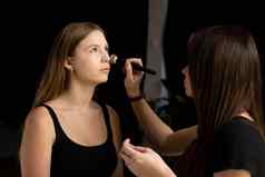 专业化妆艺术家应用液体色调基金会脸女人美时尚模型专业使脸工作室