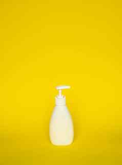 白色塑料肥皂洗发水自动售货机泵瓶孤立的黄色的背景皮肤护理乳液洗澡至关重要的产品洗发水瓶浴身体乳液细液体手洗