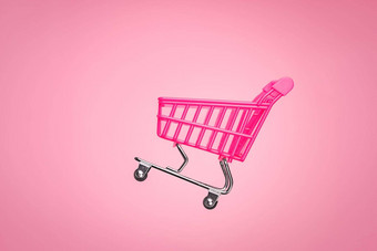 粉红色的购物电车超市概念空电车车孤立的粉红色的背景出售车商店在线市场玩具粉红色的概念销售在线购物车超市销售购物象征