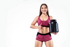 快乐健康的肌肉发达的年轻的健身体育女人运动员Jar体育营养蛋白质获得者酪蛋白