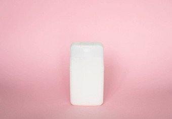 白色塑料瓶身体护理美产品工作室摄影塑料瓶洗发水淋浴过来这里噪音孤立的粉红色的背景