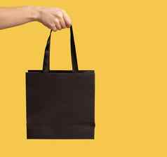 特写镜头购物袋女人手臂广告购买商店手持有黑色的包