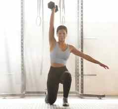 运动女人重量提升肌肉强度培训健身活跃的年轻的女锻炼锻炼室内健身房强大的健美的身体健康的生活方式